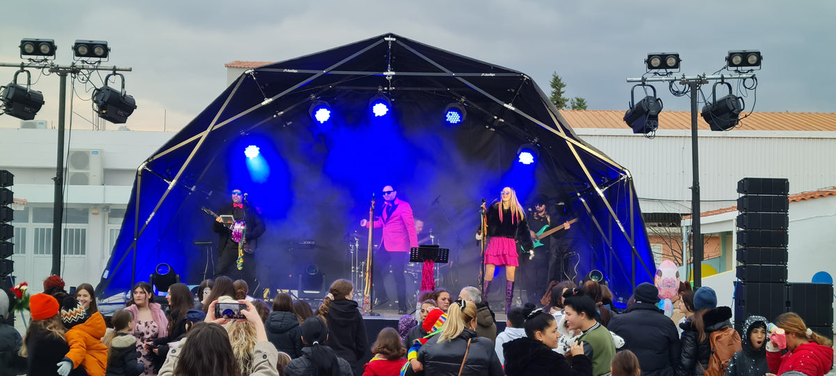 Konligo Fastival event structure with black membrane and outside backdrop hosting an energetic live band performance on an outdoor stage, with crowd gathered in front, now available on MTN SHOP US. - imagen 12