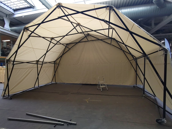 Konligo Fastival event structure with full white outside backdrop and membrane cover assembled indoors, now available on MTN SHOP US.