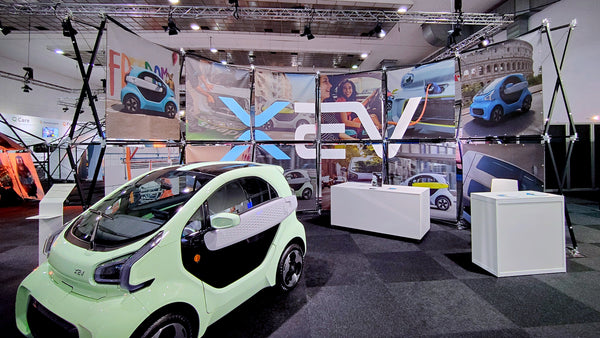 Konligo Luno Wall modular display structure showcasing promotional graphics for electric vehicles at an indoor auto exhibition, now available on MTN SHOP US.
